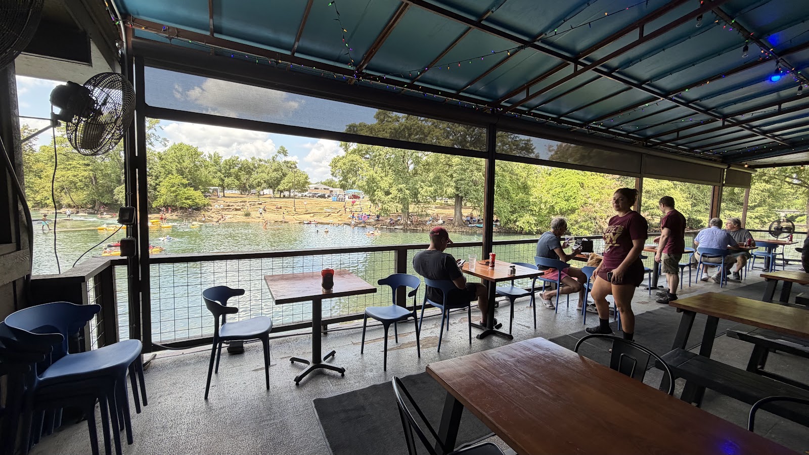 Covered riverside deck seating overlooking the San Marcos River