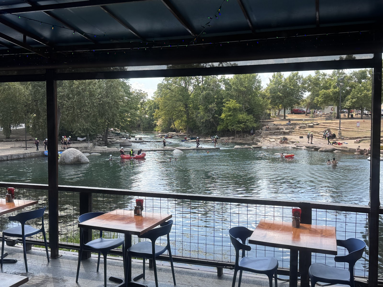 View of the San Marcos River rapids from the covered deck at Ivar's River Pub